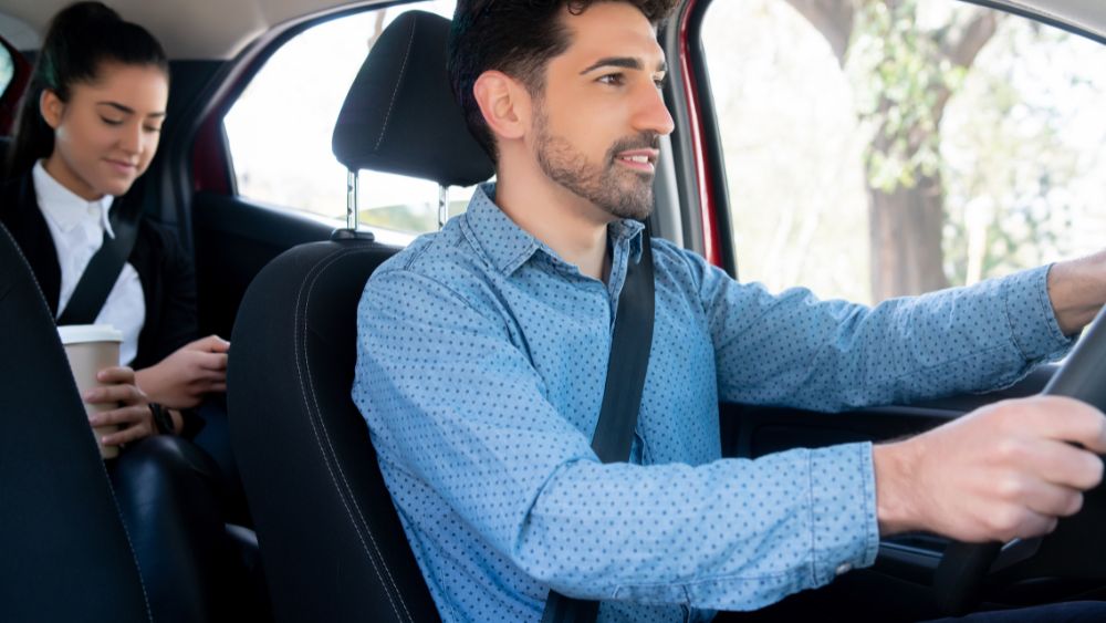 Professional driver with passengers wearing seat belts